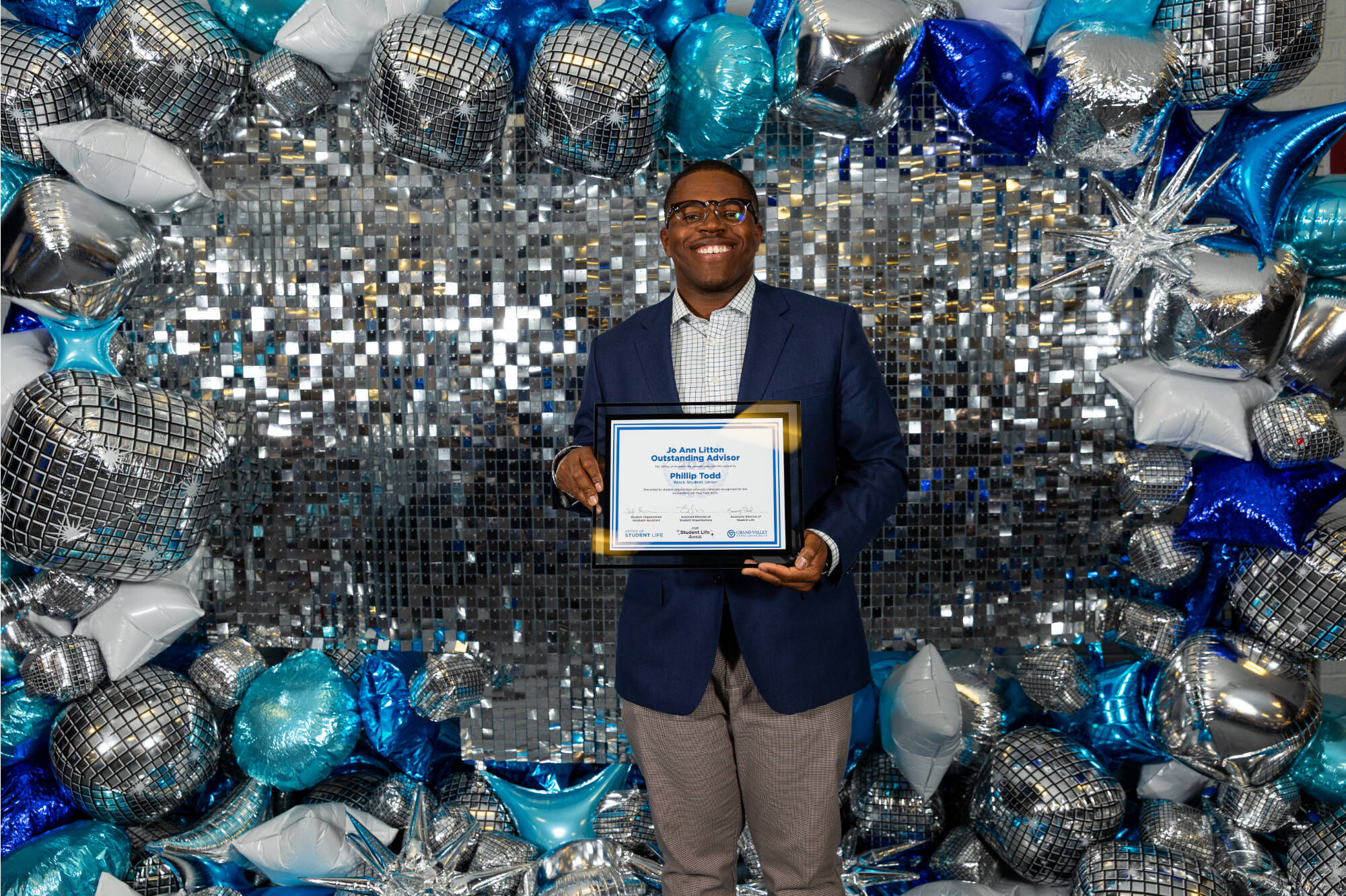 An individual holding up an award certificate